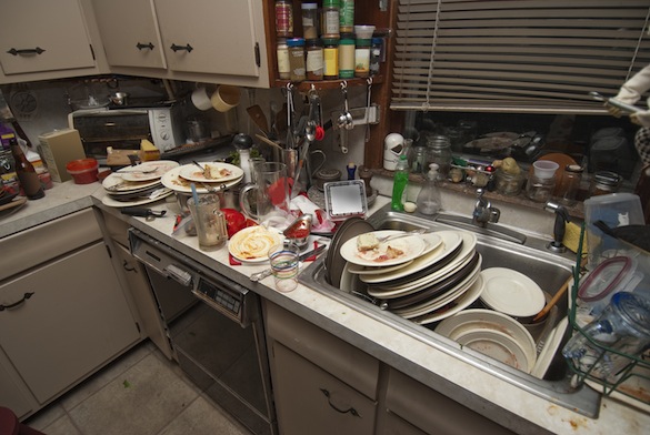 Dirty dishes piled up in sink after a party