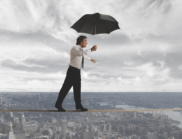 Businessman trying to keep balance